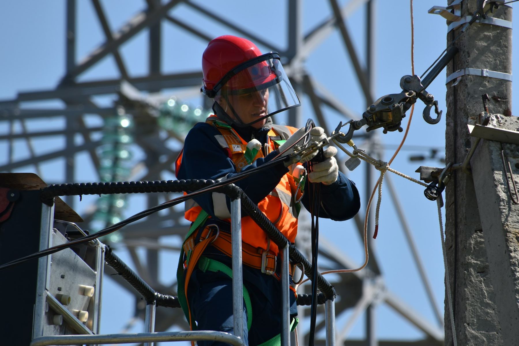 Technician working on overhead power equipment